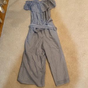 Vestique jumpsuit with belt to cinch waist.